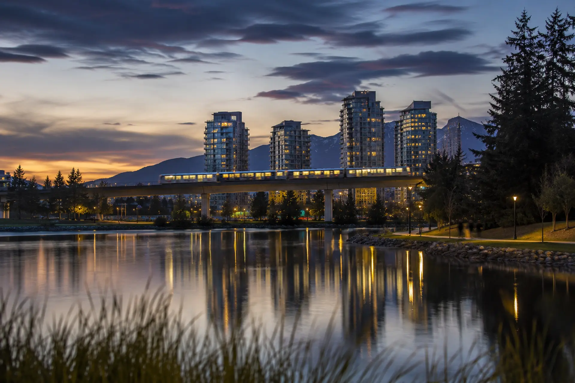 Lafarge Lake at dusk with the Evergreen SkyTrain crossing in the background, Coquitlam BC